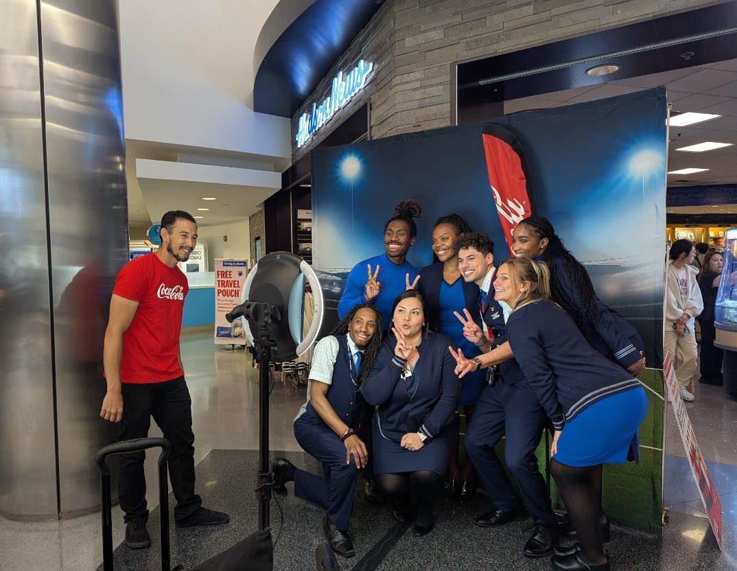 Coca-Cola brand ambassadors promoting the upcoming 2026 World Cup at an airport