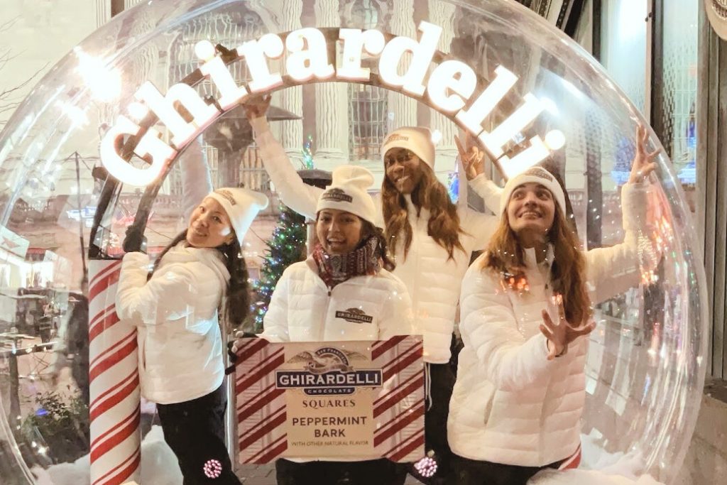 Holiday experiential marketing ideas like a snowglobe photo opp 