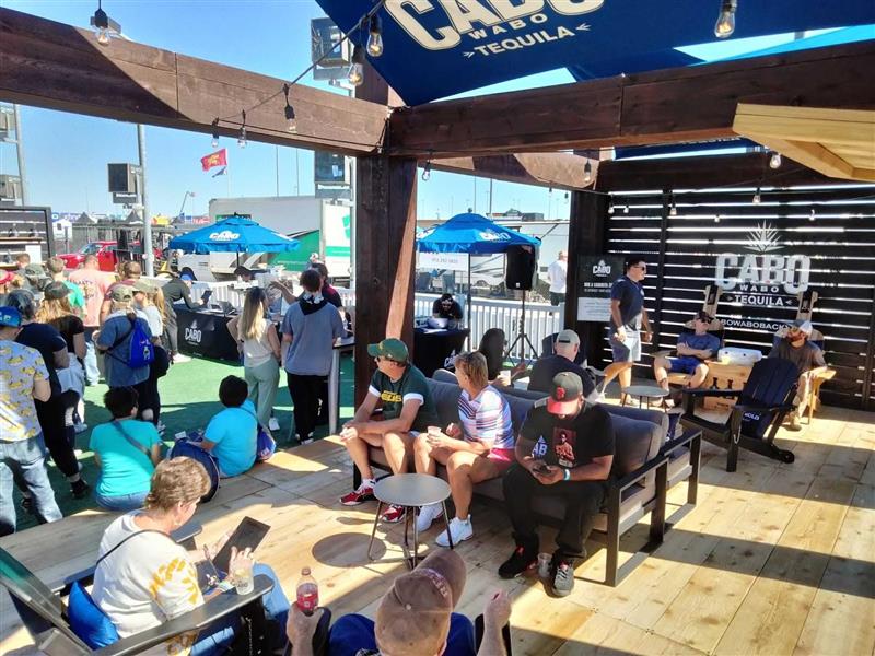 Interactive experiential marketing setup with branded footprint and engaged attendees